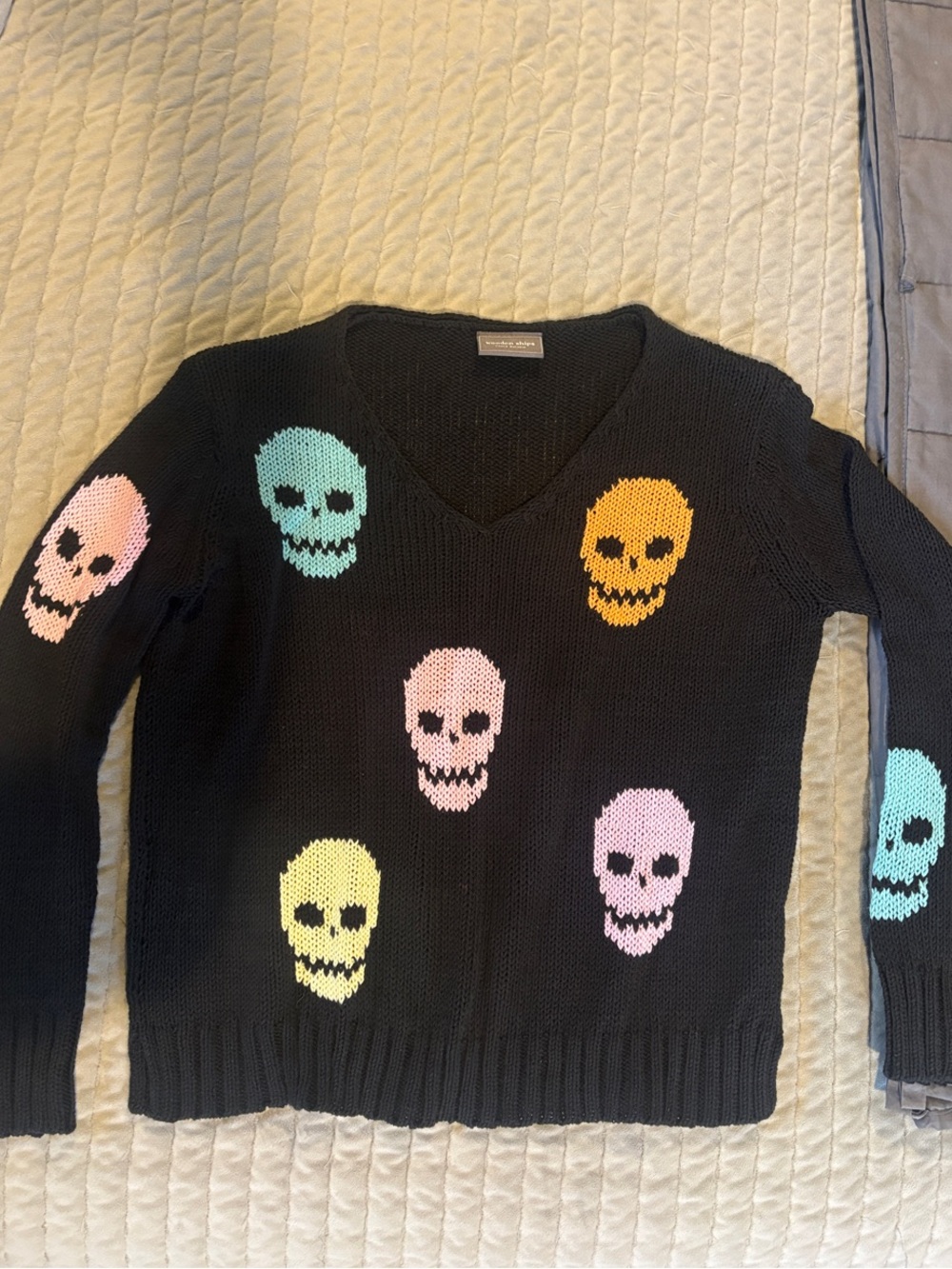 Wooden Ships Black V-Neck Sweater with Pastel Skull Motif